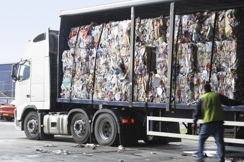 Workers efficiently loading waste into a skip